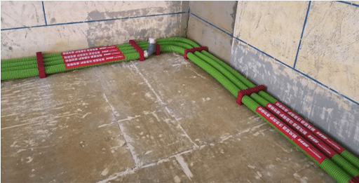 pipes and coils of central air conditioner fastened on the wall